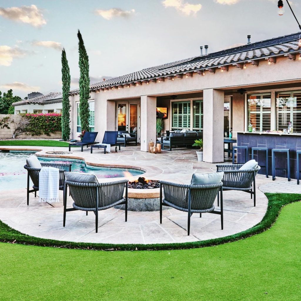 Luxurious backyard with pool fire pit and Spanish-style house