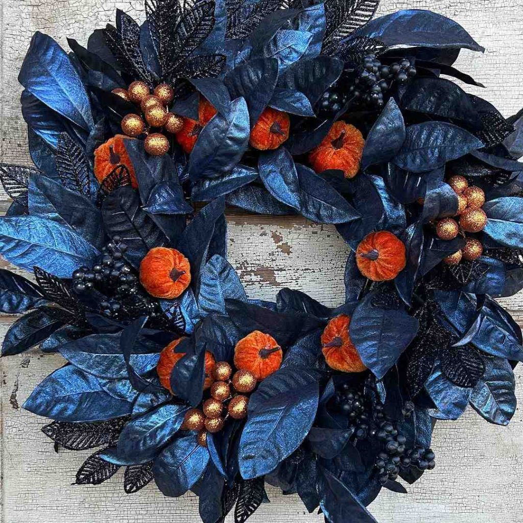 Blue wreath with orange pumpkins and gold accents