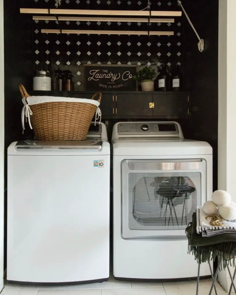 Dark laundry room with diamond wallpaper and white appliances