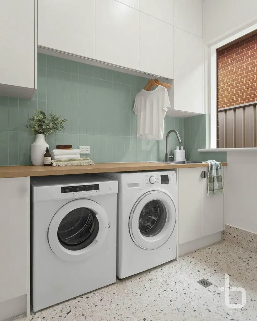 Mint-tiled laundry room with wooden counter and white appliances