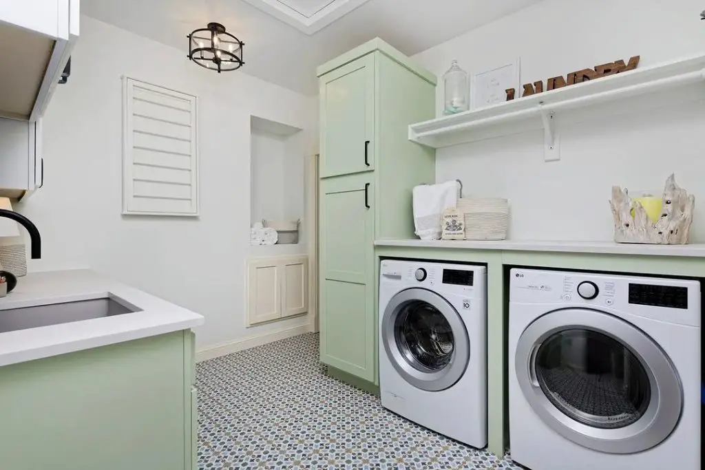 Mint green and white laundry room with patterned floor tiles