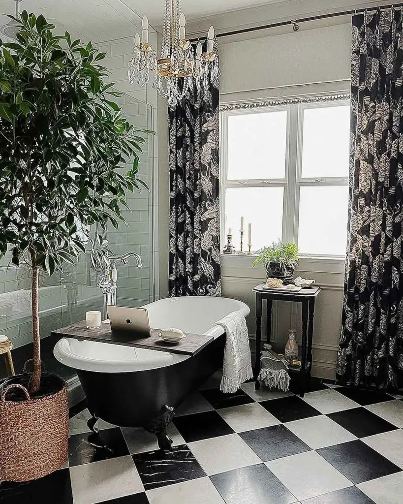 Elegant black and white bathroom with clawfoot tub and chandelier