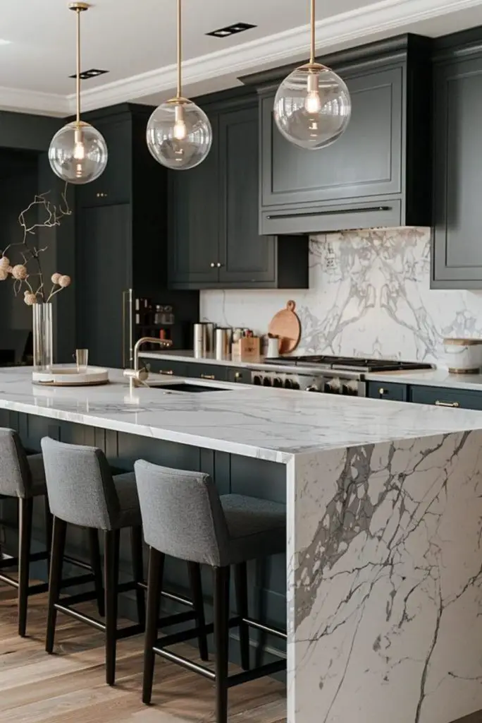 Elegant dark kitchen with marble island and glass pendant lights
