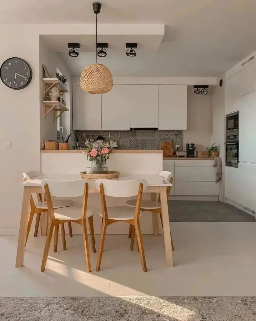 Minimalist white kitchen with dining area and woven light fixture