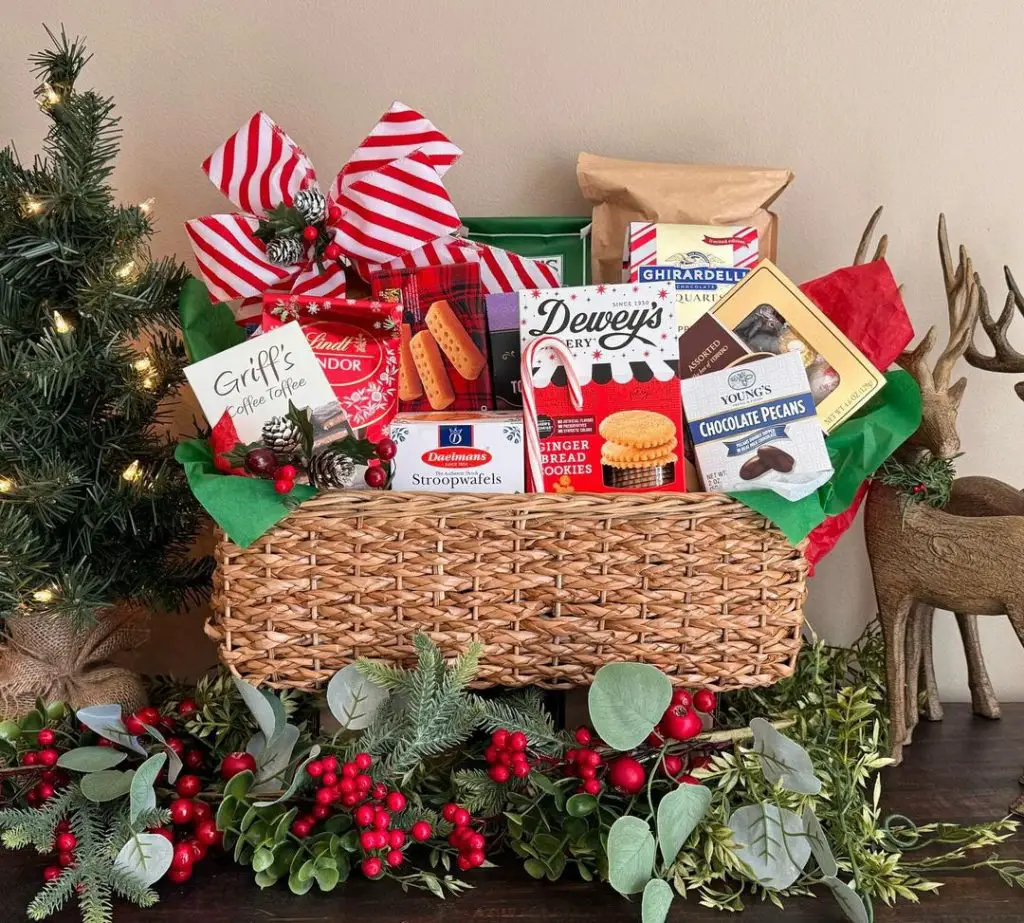 Wicker basket filled with festive treats surrounded by Christmas decorations