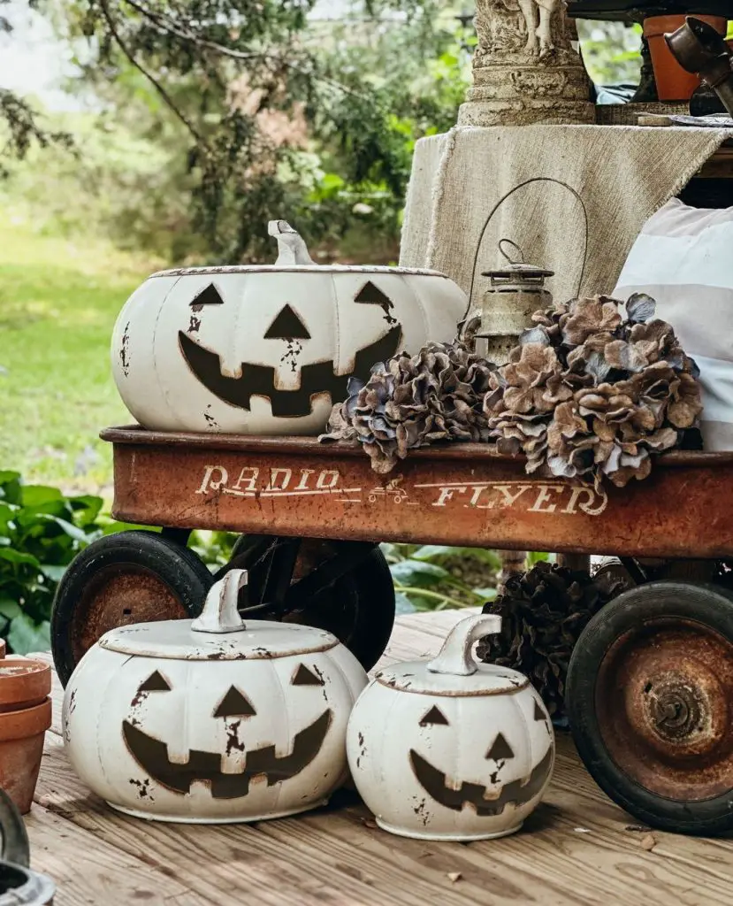 Vintage wagon with white ceramic pumpkins and dried flowers.
