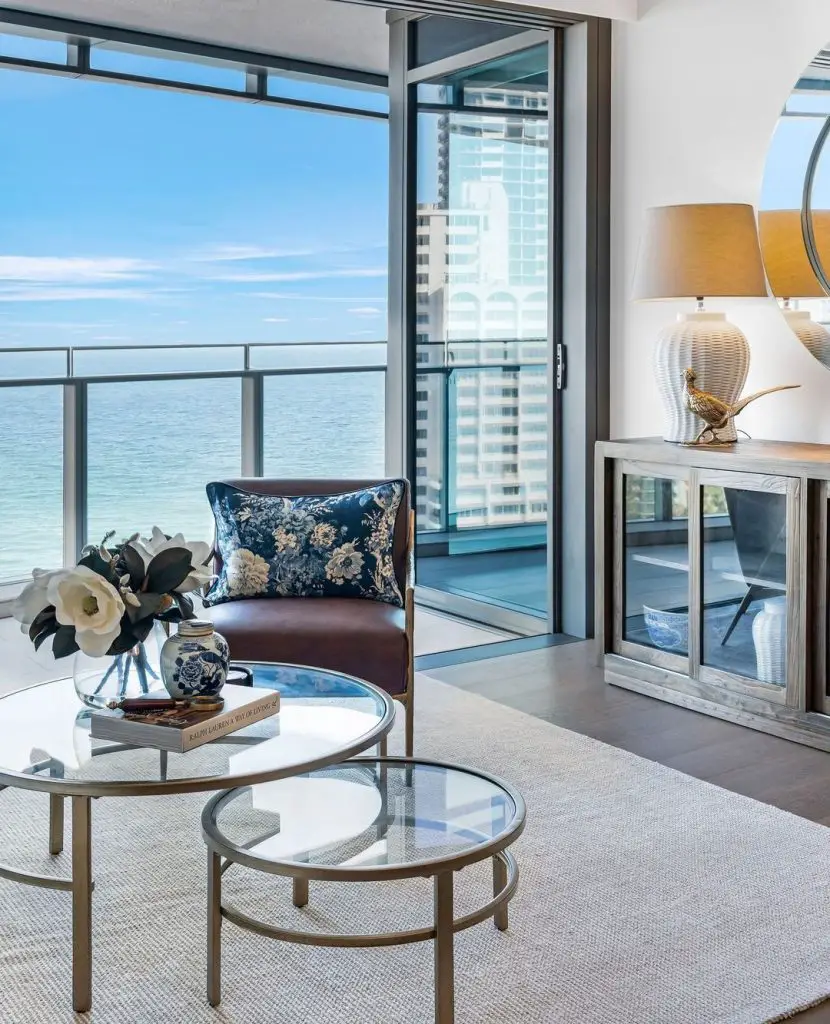 Luxurious oceanfront living room with glass coffee tables and stunning sea view