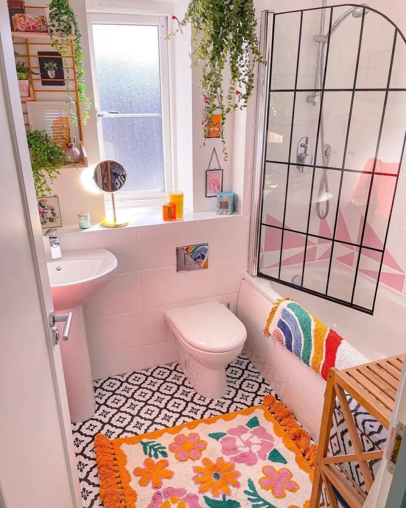 Pink bathroom with plants hanging planters and colorful decor