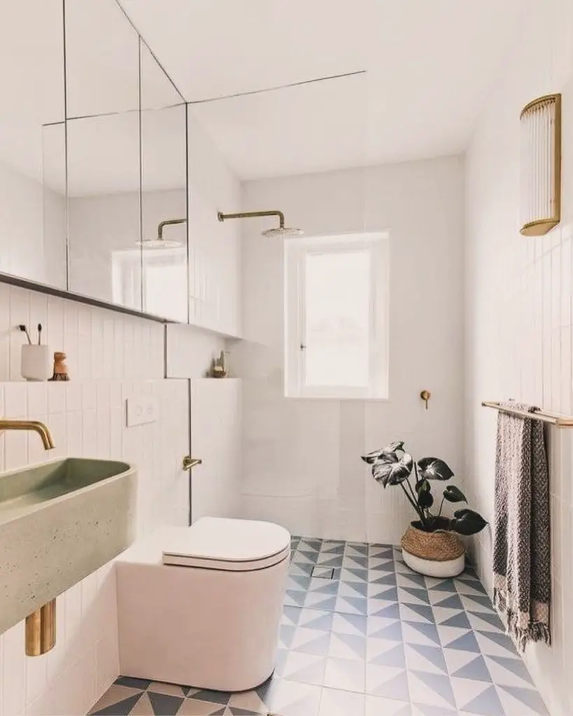 White bathroom with geometric floor and pink toilet