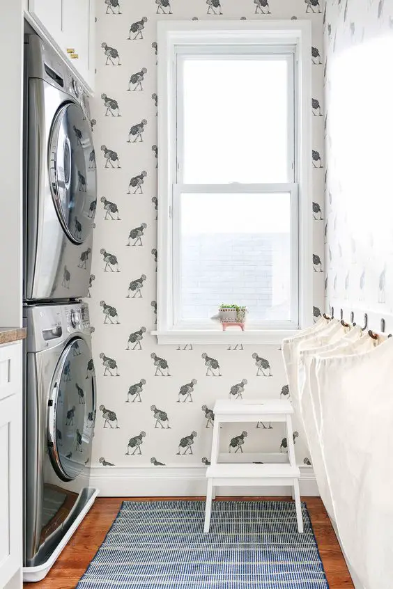 Laundry room with ostrich wallpaper stacked washer dryer window and rug