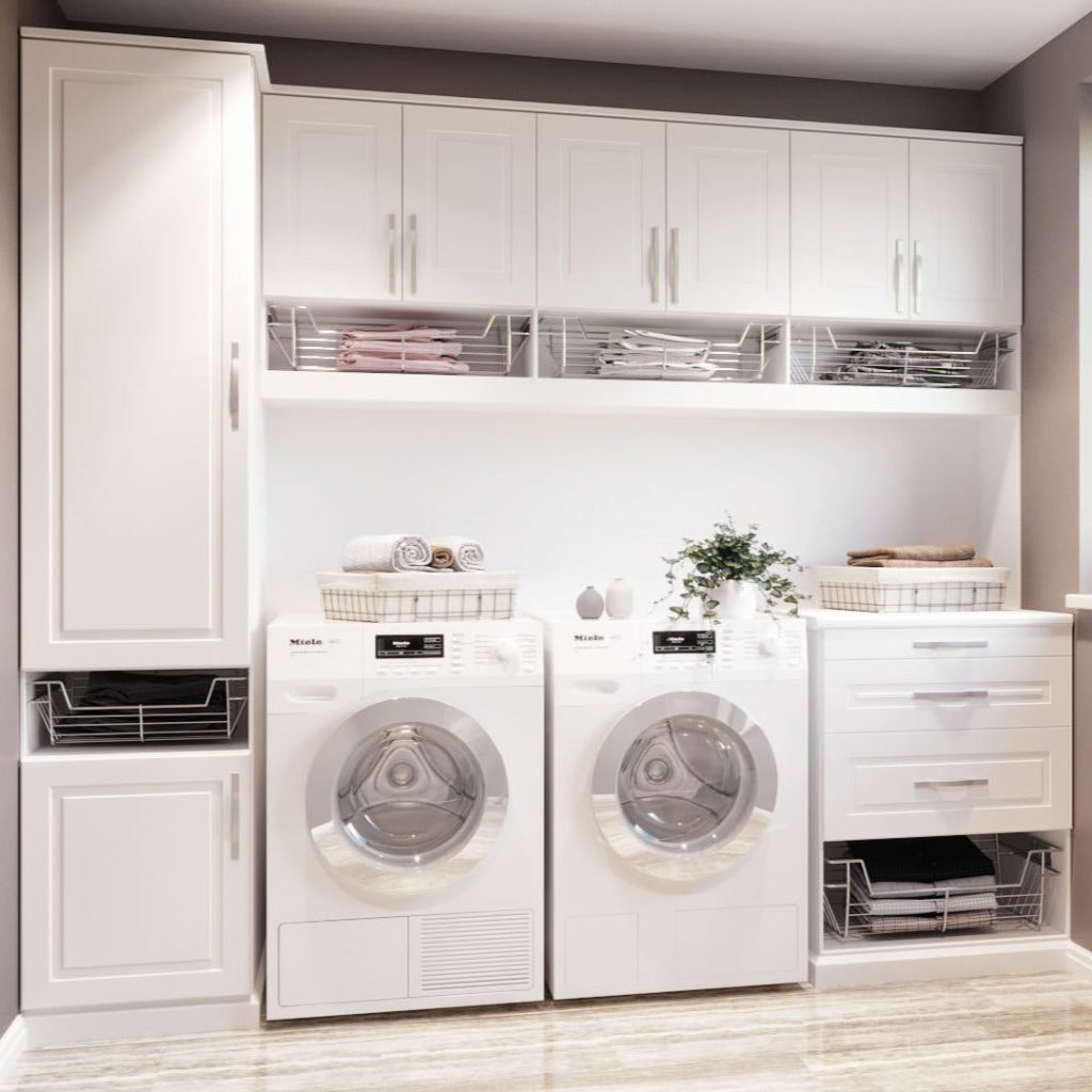 Elegant white laundry room with built-in storage and Miele appliances