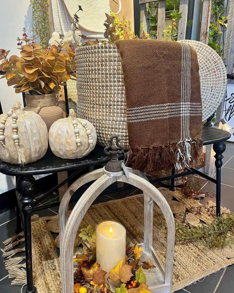 Fall decor with buffalo check throw and wooden pumpkins