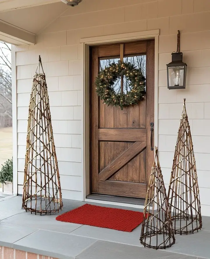 Farmhouse porch with lit wreath and wicker trees