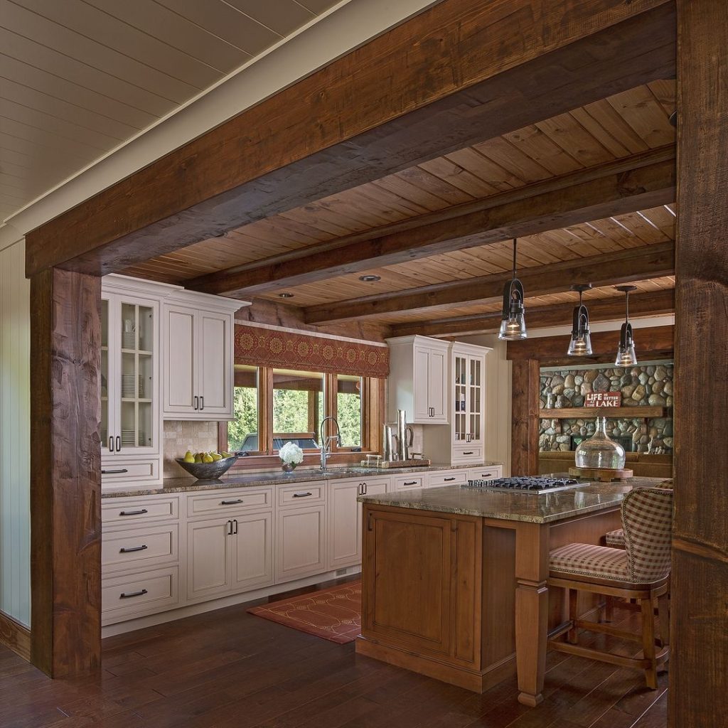 Rustic kitchen with wooden beams white cabinets and lake-themed decor