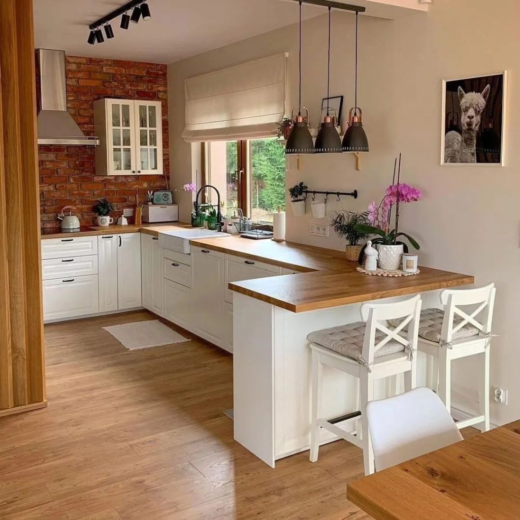 Cozy kitchen with brick wall and white cabinets