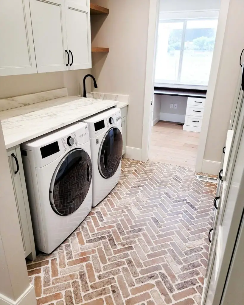 Laundry room with white appliances brick floor and marble countertop