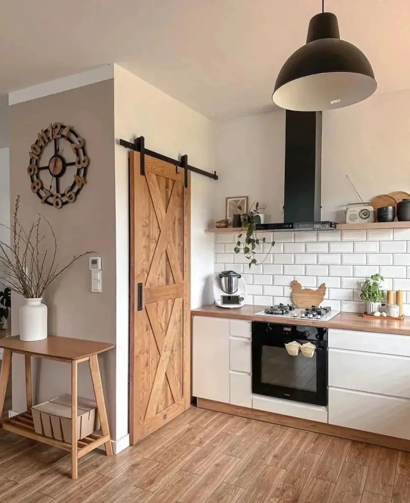 Kitchen with barn door white cabinets and wood accents