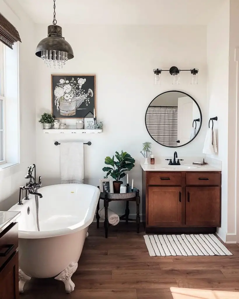 Farmhouse bathroom with clawfoot tub and rustic chandelier