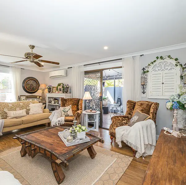 Cozy living room with rustic furniture and bright decor.