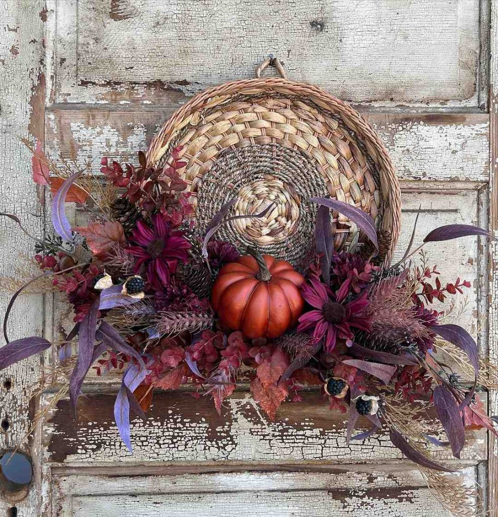 Autumn basket arrangement with pumpkin and foliage