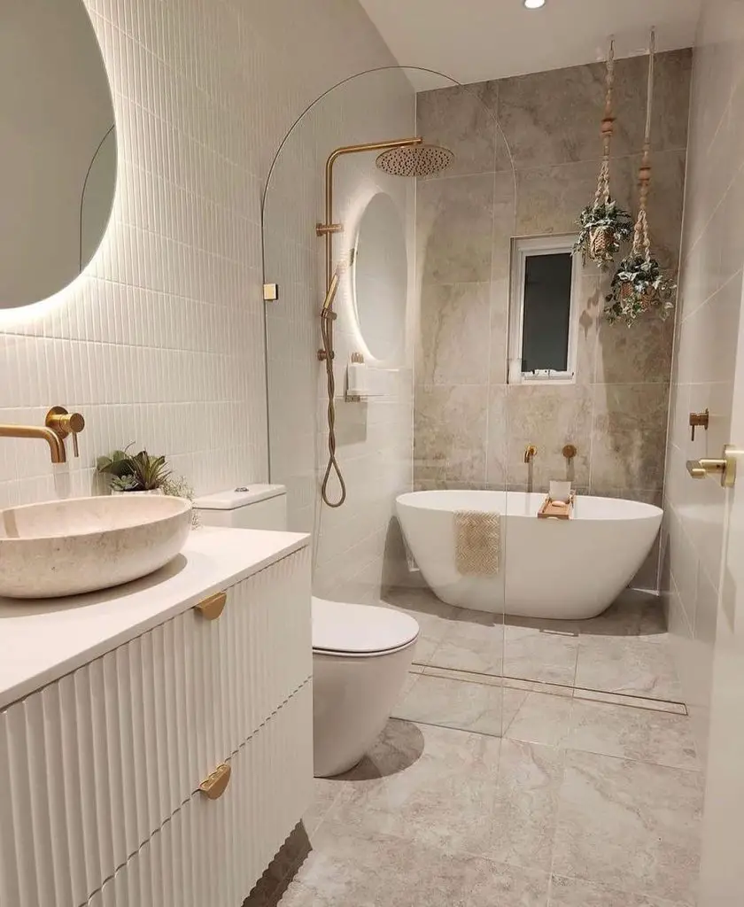 Elegant white bathroom with freestanding tub and gold fixtures