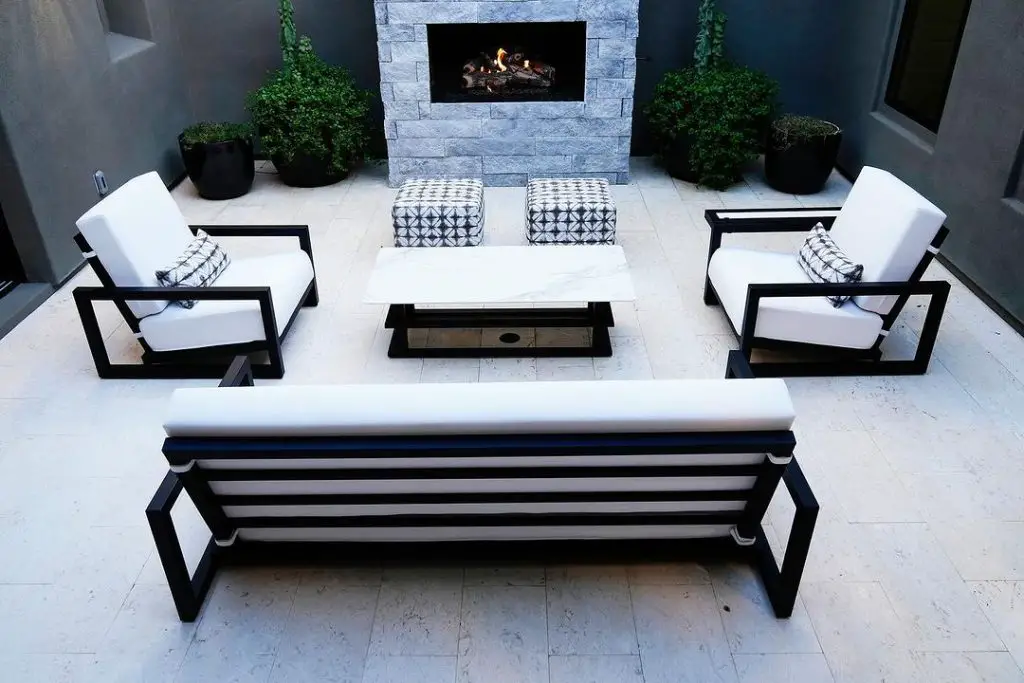 Modern monochrome patio with stone fireplace