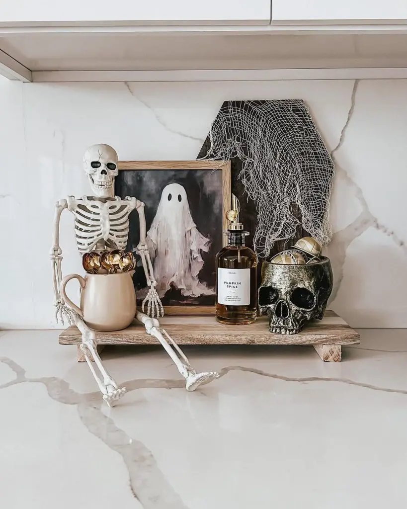 Stylish Halloween shelf decor with skeleton ghost painting and skulls