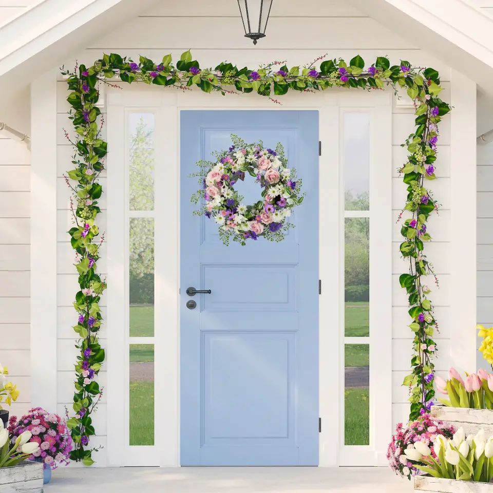 Blue door with floral wreath and green garland arch