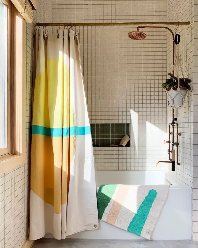 Minimalist bathroom with colorblock shower curtain and geometric bath mat