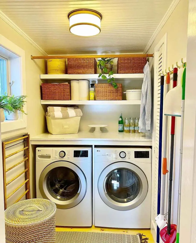 Bright laundry room with white appliances organized shelving and yellow accents