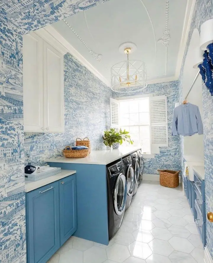 Blue toile wallpapered laundry room with modern appliances.