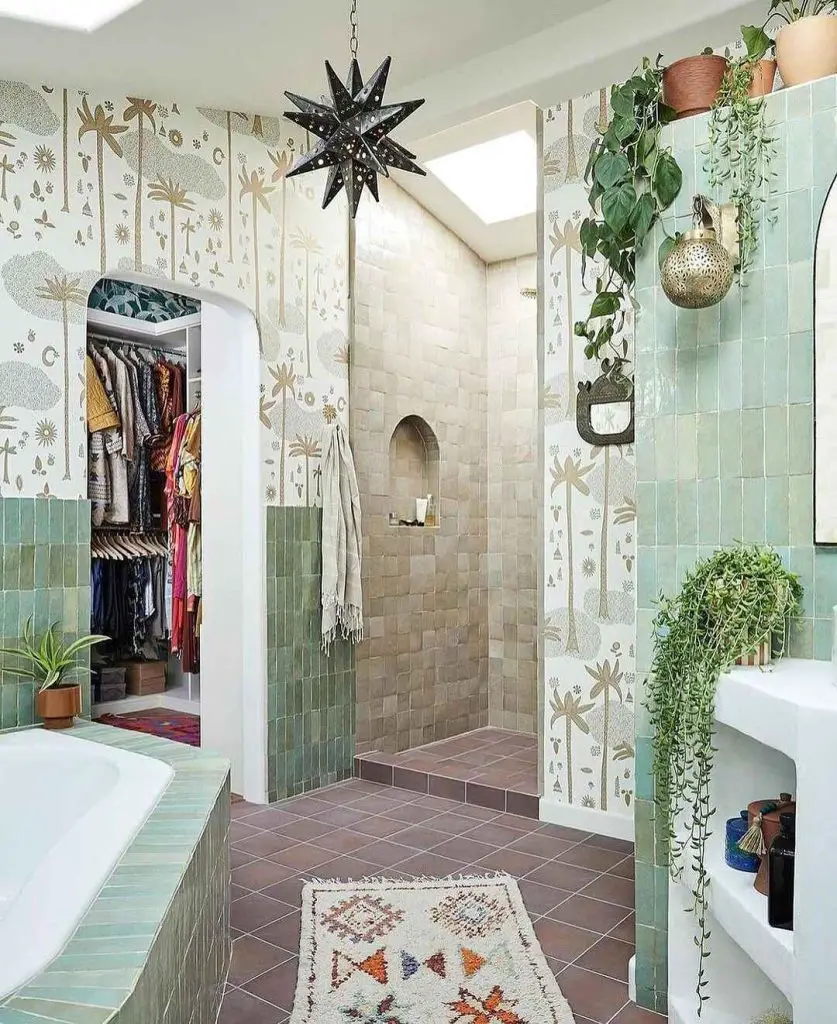 Bohemian bathroom with mint tiles, tropical wallpaper, and plants