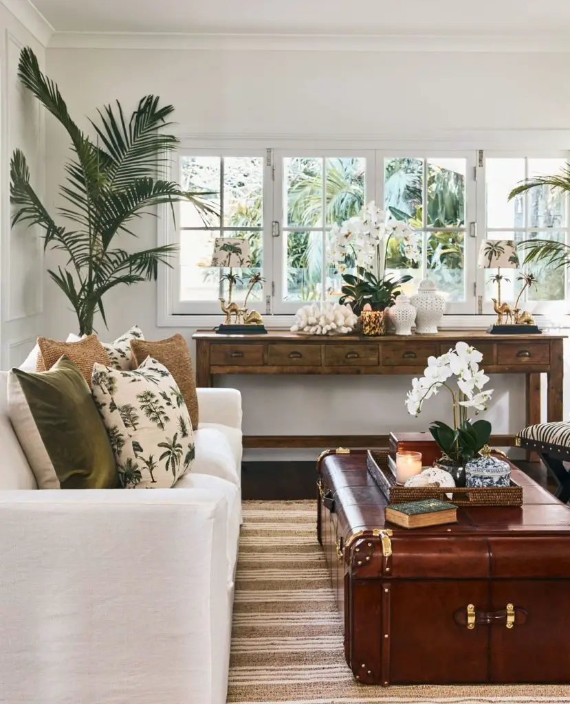 Tropical-themed living room with vintage trunk coffee table