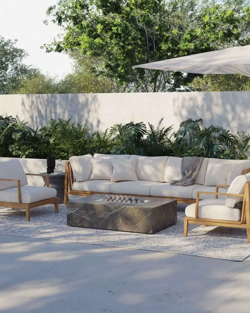 Modern outdoor lounge with white furniture and tropical plants