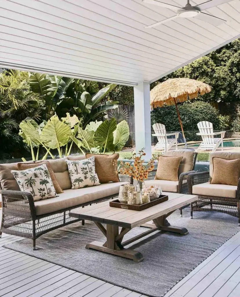 Covered patio with tropical decor overlooking pool