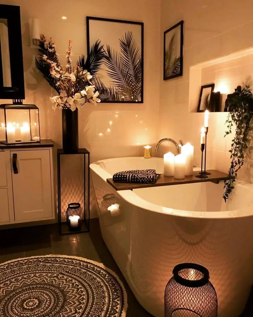 Candlelit bathroom with tropical decor and bathtub.