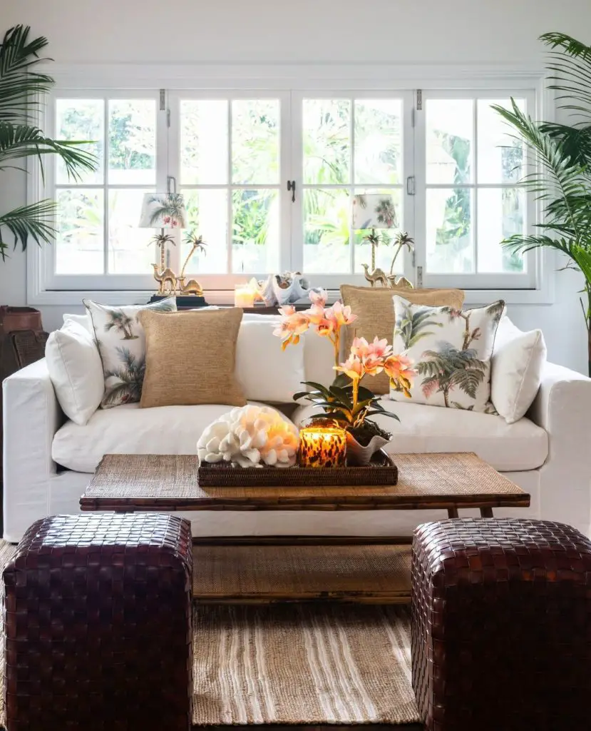 Tropical-inspired living room with wooden coffee table and orchid centerpiece