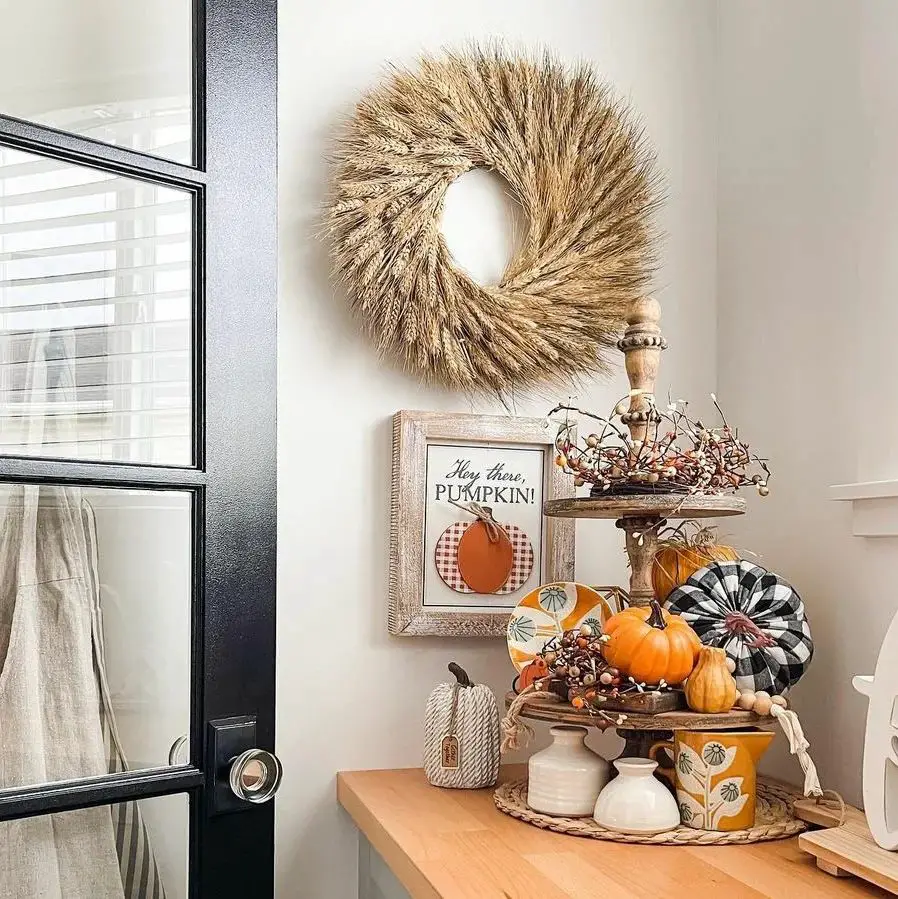 Wheat wreath above festive pumpkin display
