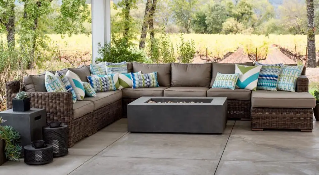 Wicker patio set overlooking vineyard landscape