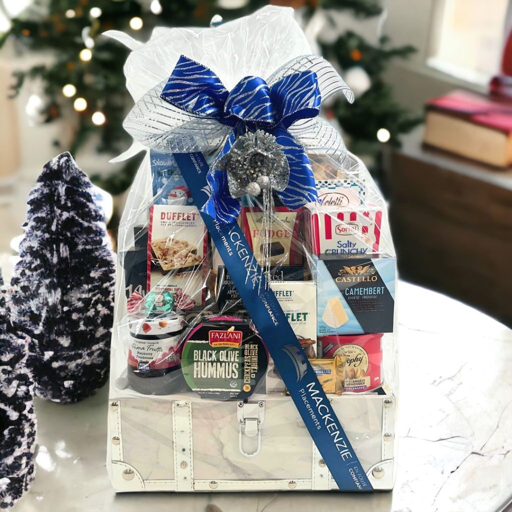 Elegant white gift basket filled with gourmet foods and festive decorations