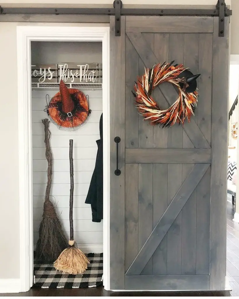 Farmhouse entryway with sliding barn door and Halloween decorations
