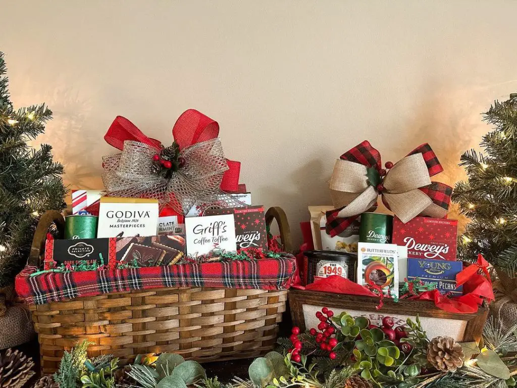 Two festive gift baskets with plaid bows surrounded by Christmas decor