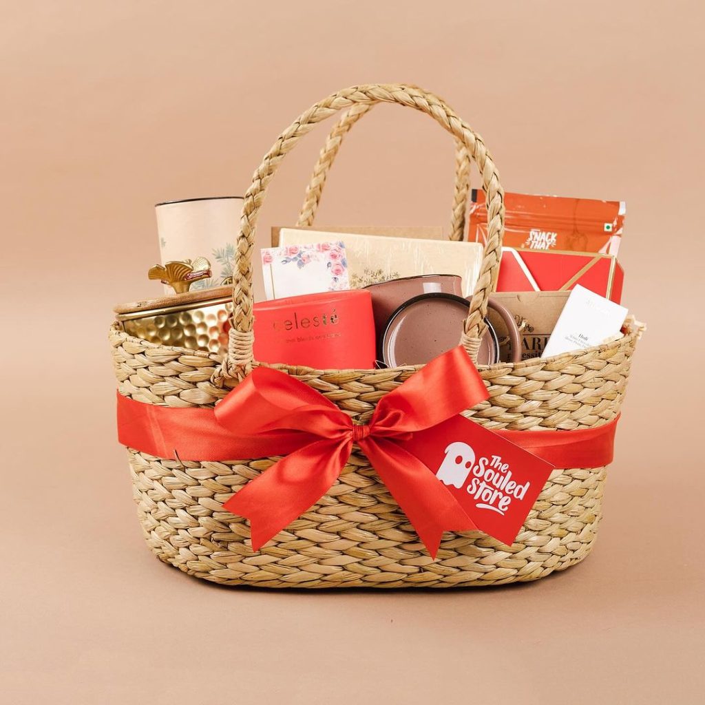 Woven basket filled with assorted gifts and red bow