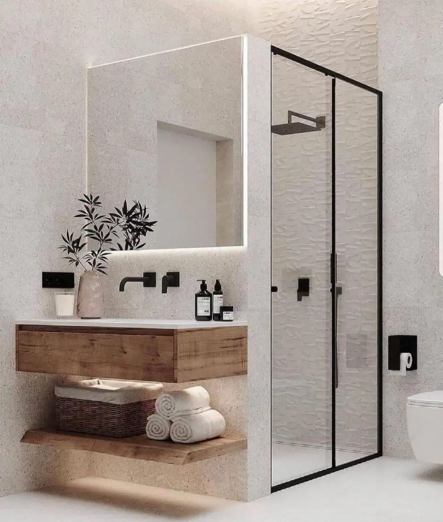 Modern bathroom with glass shower and wooden vanity.