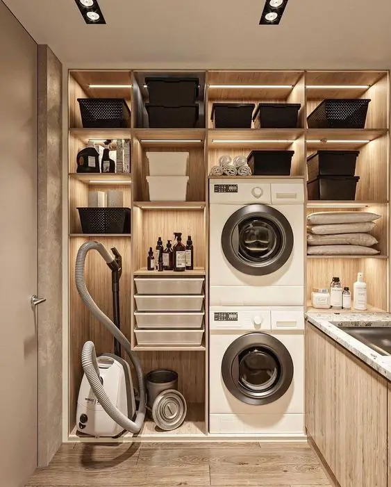Modern wooden laundry room with built-in storage and stacked appliances
