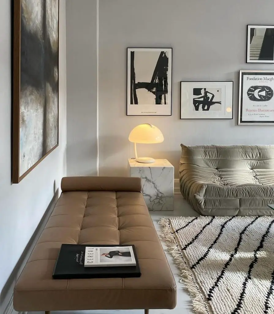 Stylish living room with gray sofa brown daybed and art gallery wall