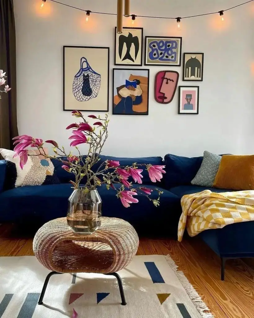 Cozy living room with blue sofa and art gallery wall