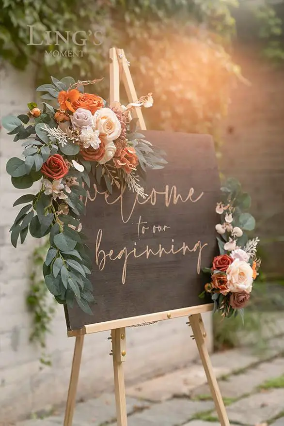 Floral embellished arch backdrop wishing welcome to beginnings