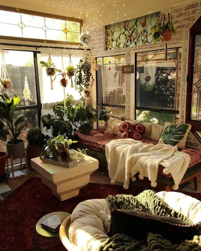 Bohemian sunroom filled with plants hanging lights and cozy seating