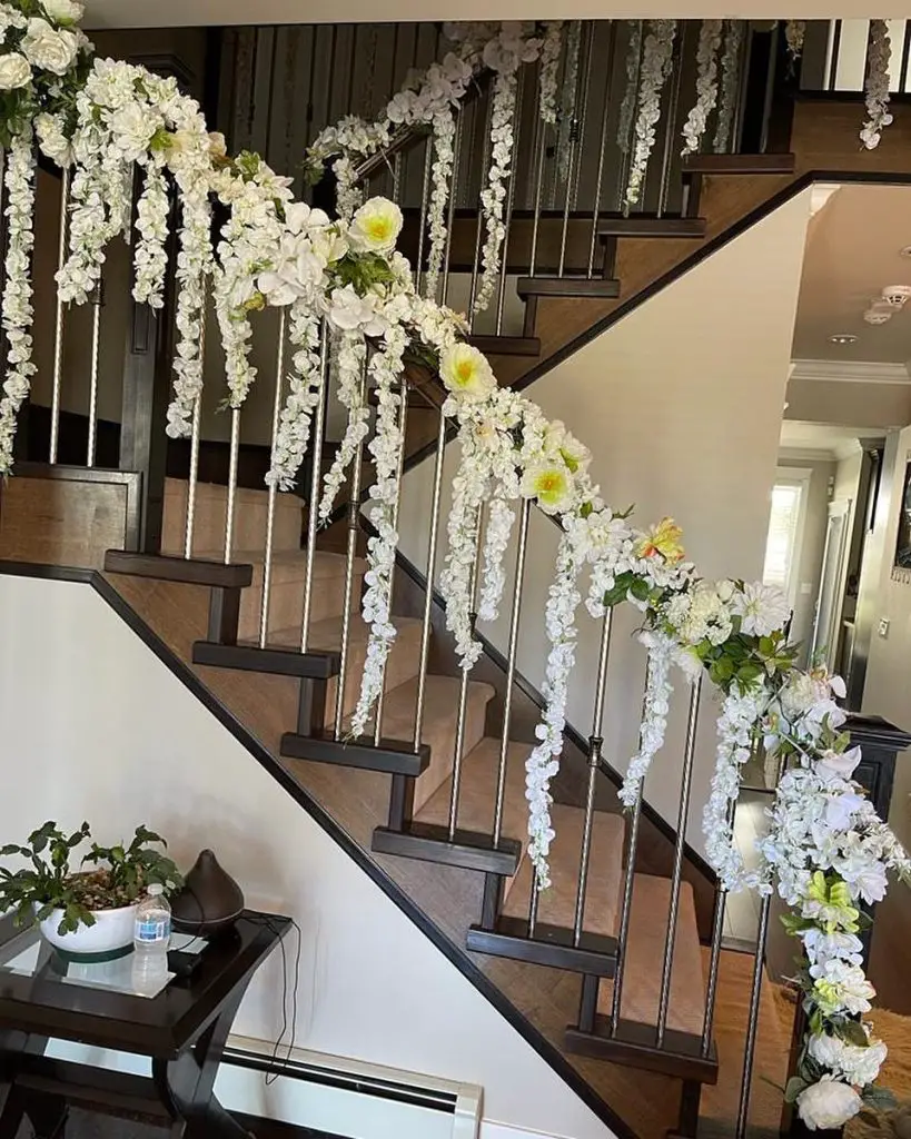 Staircase adorned with cascading white floral garlands